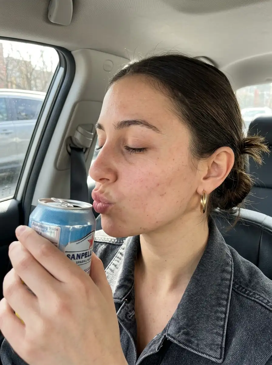 Woman_holding_can_in_car_202607112357